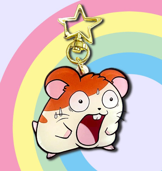 Double sided acrylic keychain of the anime hamster Hamtaro making a funny surprised face.